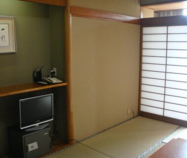 Tatami room with shoji screens, small TV and alcove at Yamaichi Bekkan in Hiroshima