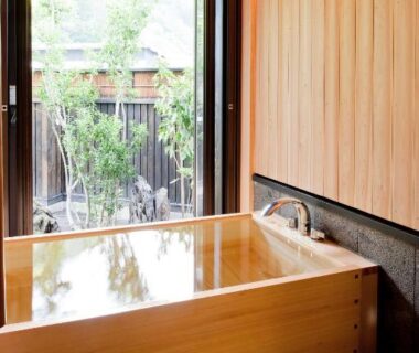 Indoor wooden soaking tub with garden view at Yamakikan, Gunma, Kantō