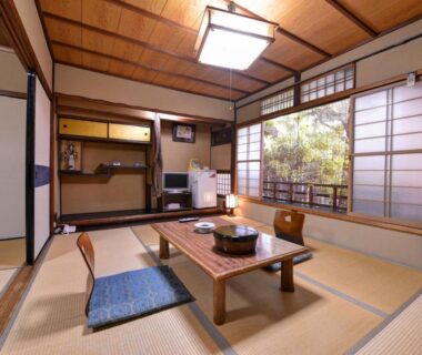 Tatami room with low table and shoji screens at Yamamoto Ryokan in Kyoto, Kansai