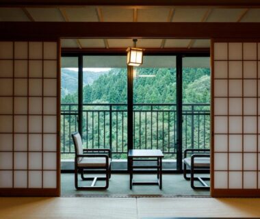 Traditional tatami room with shoji screens and balcony chairs at Yamanaka Onsen Hanatsubaki, Chūbu, Ishikawa, Japan