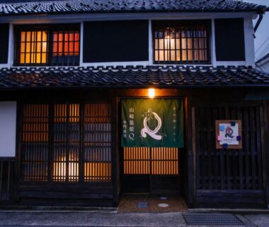 Traditional wooden lattice entrance with noren at Yamasaki Ryokan, Hyōgo, Kansai