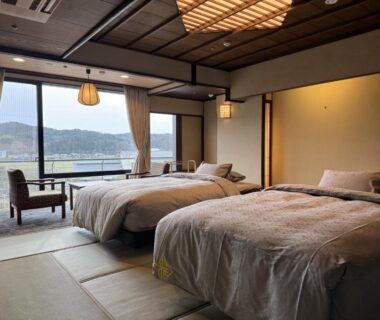 Tatami room with twin beds and water view at Yamashiro Onsen Miyabi no Yado, Ishikawa