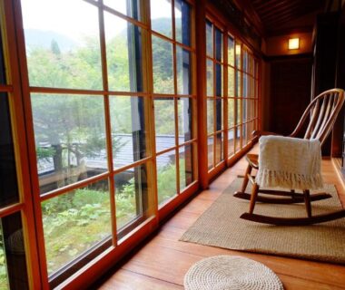 Wooden engawa with rocking chair overlooking garden at Yamazatonoiori Soene, Gifu Chūbu