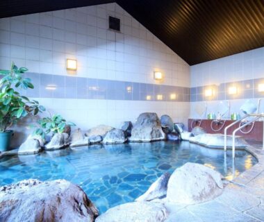 Indoor hot spring bath with rock accents and handrails at Yanagiya in Yamanashi, Chūbu, Japan