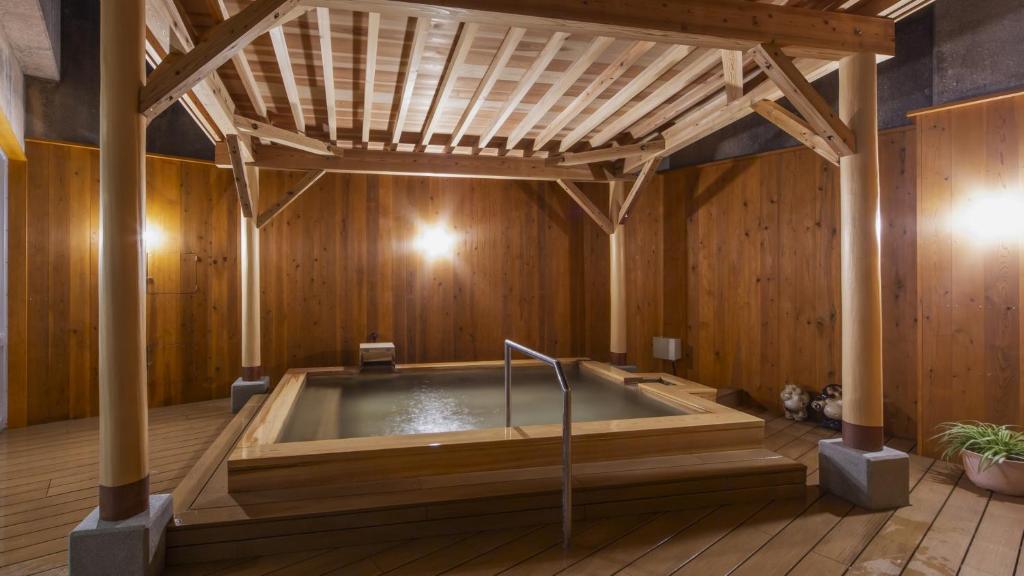 Wooden onsen bath at Yanagiya Wakayama Indoor wooden bath with exposed beams at Yanagiya ryokan in Wakayama Kansai