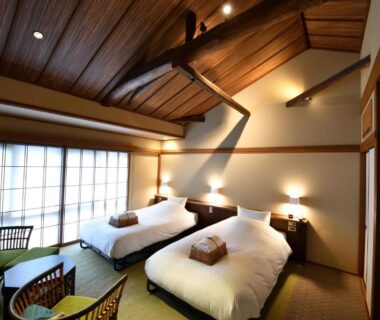 Tatami room with twin beds and shoji screens at Yasaka Yutone Kyokoyado in Kyoto