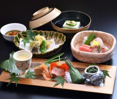 Tray of traditional Japanese small plates with sashimi and tempura at a Kyoto ryokan