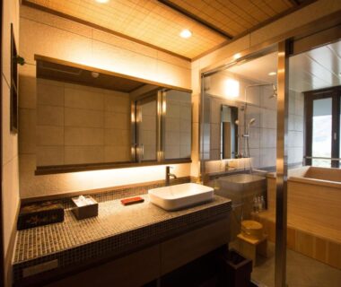 Bathroom with wooden tub, dual sinks and large mirror at Yatsusankan (children 6+), Gifu Chūbu
