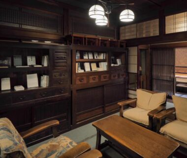 Seating area with cushioned chairs and wooden cabinetry at Yatsusankan in Gifu, Chūbu