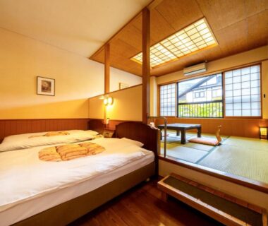 Tatami seating area and bed in Yawaragi-no-Sato Yadoya room Ōita Kyūshū Japan