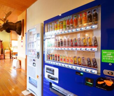 Beverage vending machines in wood-floored corridor at Yawaragi-no-Sato Yadoya, Ōita