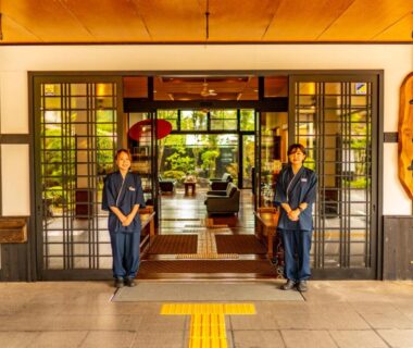 Two staff at traditional ryokan entrance, Yawaragi-no-Sato Yadoya, Ōita, Kyūshū