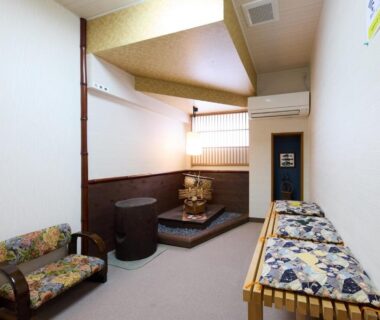 Compact tatami alcove with low table and floral bench in Yodoya ryokan, Hyōgo, Kansai