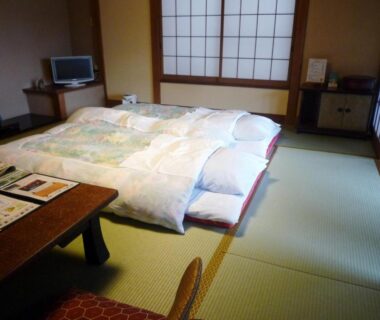 Traditional tatami room with futon bedding, shoji screens and low table at Yokikan in Shizuoka, Chūbu, Japan