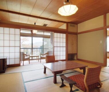 Traditional tatami room with low table, shoji screens and balcony at Yokikan in Shizuoka, Chūbu, Japan
