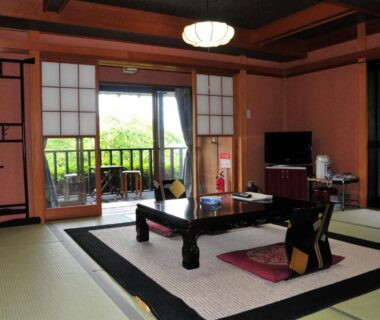 Traditional tatami room with low table, shoji doors and balcony at Yokohama Fujiyoshi Izuten in Shizuoka