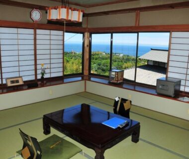 Traditional tatami room with shoji screens and low table at Yokohama Fujiyoshi Izuten overlooking coastal Shizuoka scenery, Chūbu
