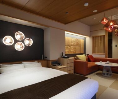 Tatami floor with Western bed, sofa and shoji screens at Yorokobinoyado Takamatsu in Gunma Kanto