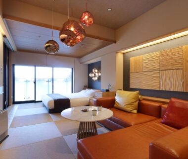 Modern tatami seating area with low table and leather sofas at Yorokobinoyado Takamatsu in Gunma, Kantō