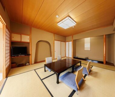Traditional tatami room with low table, floor chairs and shoji screens at Yorozuya, Nagano Chūbu
