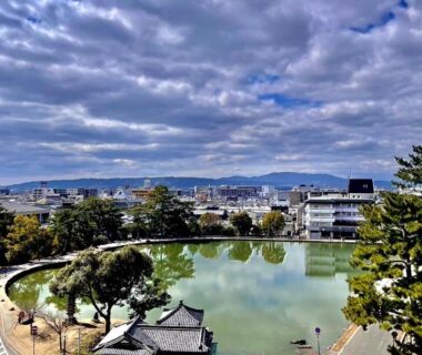 Curved city pond with cloudy sky near Yoshidaya Ryokan よしだや in Nara, Kansai