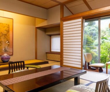 Traditional tatami room with low table, shoji screens and garden view at Yoshiike Ryokan in Kanagawa