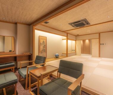 Spacious tatami room with low table, seating area, shoji screens and tokonoma at Yoshiike Ryokan, Kanagawa