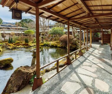 Wooden covered corridor beside a pond and moss garden at Yoshimatsu in Kanagawa Japan