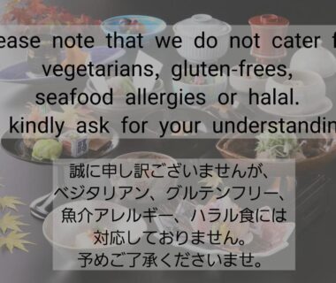 Bilingual dietary notice over assortment of small Japanese dishes at Yoshimatsu in Kanagawa