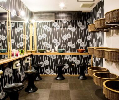 Dressing area with mirrors, stools and wicker baskets at Yoshino Ryokan, Shizuoka