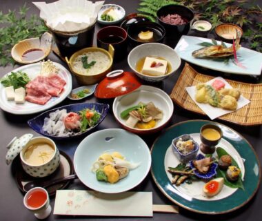 Varied small ceramic and lacquer dishes arranged for a traditional ryokan meal at Yoshinoonsen Motoyu in Nara