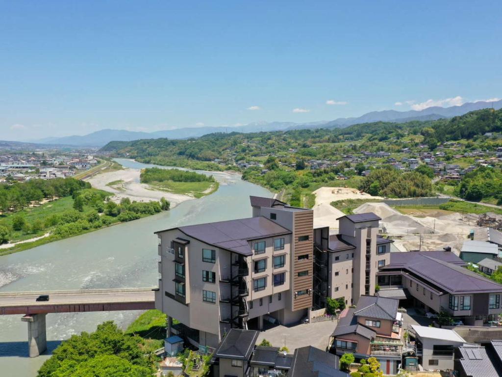 Riverside aerial view Yoshinotei Nagano Chūbu Aerial riverside view of Yoshinotei by a river and bridge with distant mountains in Nagano Chūbu