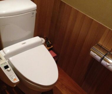 Compact bidet toilet with wood paneling and flooring at Yoyokaku in Saga, Kyūshū Japan