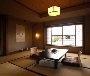 Traditional tatami room with low table, cushions, shoji window and hanging lantern at Yoyokaku, Saga