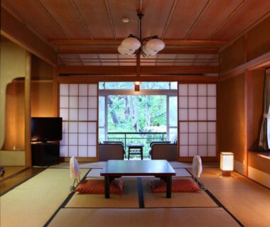 Traditional tatami room with low table and shoji screens at Yudanaka Yumoto in Nagano