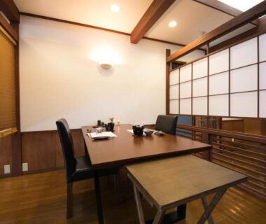 Low table with chairs and shoji screens in a wooden dining room at Yufuin Bath Satoyamasafu, Ōita
