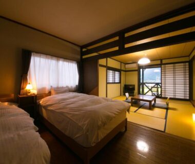 Twin beds with tatami sitting area and shoji screens at Yufuin Bath Satoyamasafu, Oita