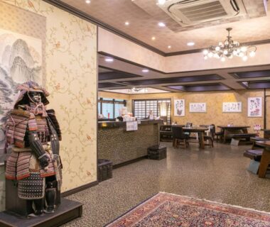 Lobby with samurai armor display and seating area at Yufuin Besso Shikisai in Ōita