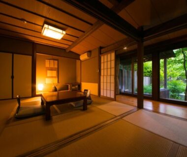 Tatami room with low table, shoji screens and garden view at Yufuin Gettouan, Ōita, Kyūshū