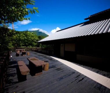 Outdoor wooden terrace with bench seating at Yufuin Gettouan in Oita, Kyushu