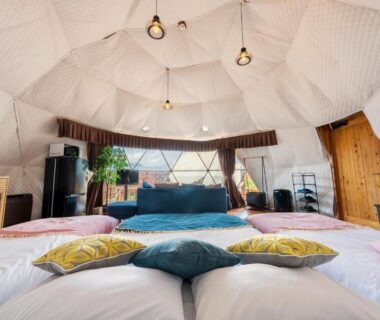 Futon beds and cushions inside a white geodesic dome room at Yufuin Hanarenoyado Yukagetsu Oita