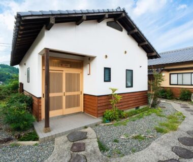 Traditional entrance with wooden sliding doors and stone path at Yufuin Hanarenoyado Yukagetsu, Oita, Kyushu, Japan