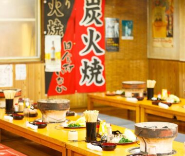 Traditional ryokan dining with low wooden tables and tabletop grills at Yufuin Inakamura Inakaso, Ōita
