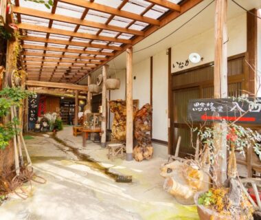 Covered wooden corridor with potted plants at Yufuin Inakamura Inakaso, Oita, Kyushu, Japan