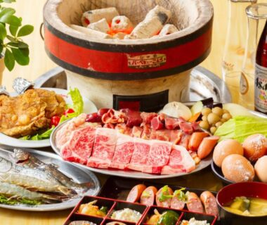 Raw sliced meat, fish, eggs and vegetables arranged for tabletop cooking at Yufuin Inakamura Inakaso in Ōita