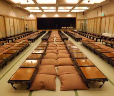 Long tatami banquet room with low tables and zabuton at Yufuin Kotobuki Hananosho, Oita, Kyushu, Japan