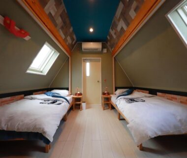 Loft-style twin bedroom with skylights, wooden floor and bedside tables at Yufuin Onsen 8A1 Yaeichi Oita
