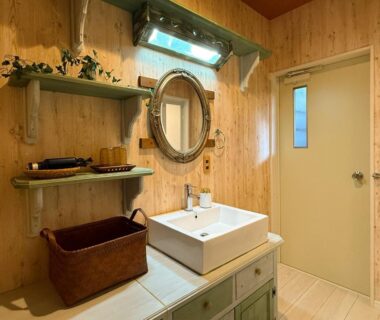 Wooden bathroom vanity with mirror, wicker basket and shelving at Yufuin Onsen 8A1 Yaeichi, Ōita