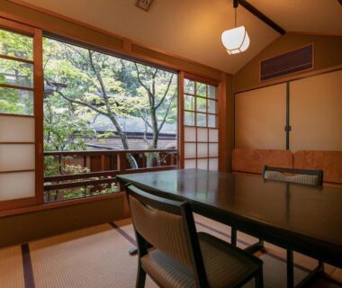 Tatami room with dining table and shoji screens showing courtyard, Yufuin Onsen Hinoharu Ryokan Ōita