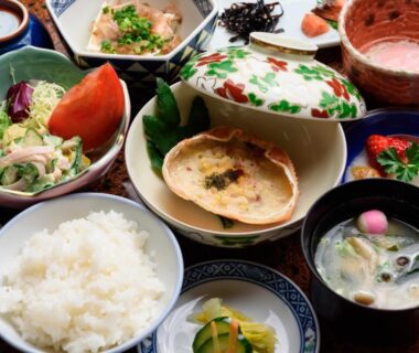 Assorted Japanese breakfast dishes with rice, soup, pickles and salad at Yufuin Onsen Oyado Jinnouchi Ōita